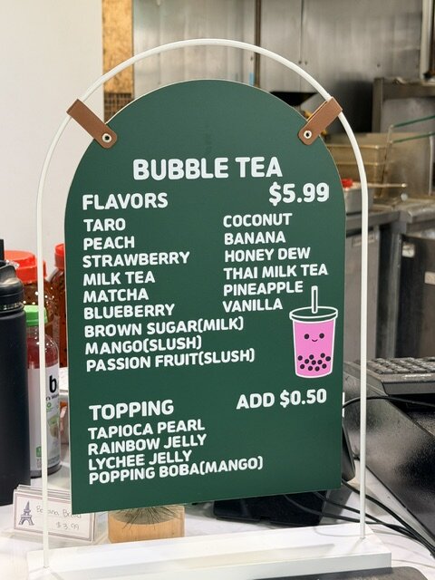 Bubble tea flavors and toppings sign.