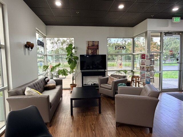 The lounge at The Breakroom — soft sofas, marble tables, and big windows.